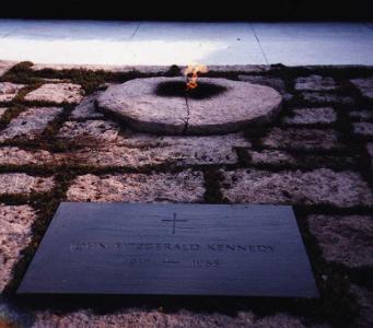 Kennedy's grave in Arlington National Cemetery is marked by what?