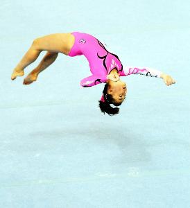 What is the term for the twisted somersault performed on the floor in artistic gymnastics?