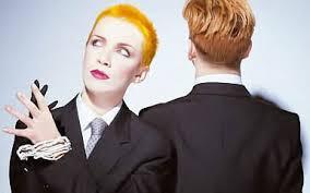 Which Eurythmics song featured the lead singer in a suit at a board meeting at the start of the video.