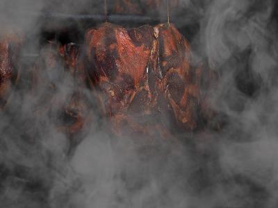 Which method of food preservation involves exposing food to smoke from burning wood or herbs?