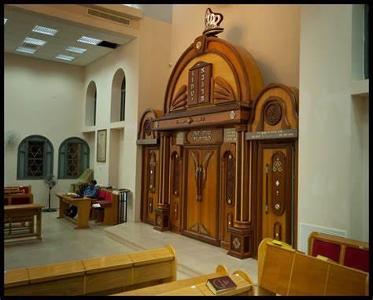 What is the name of the special cabinet where Torah scrolls are kept in a synagogue?
