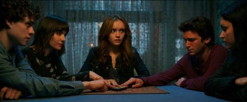 Which horror movie features a family terrorized by a haunted Ouija board?