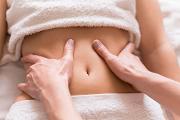 What conditions or issues can holistic abdominal therapy help with?