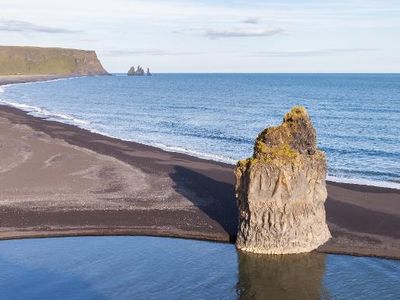 Which landform is a low-lying coastal landform formed by deposition of sediments?