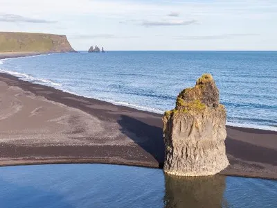 Which landform is a low-lying coastal landform formed by deposition of sediments?