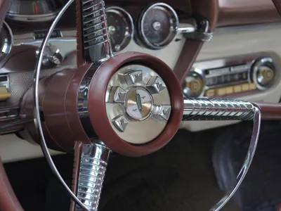 When should you start turning the steering wheel during parallel parking?