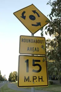 What does a roundabout sign indicate?