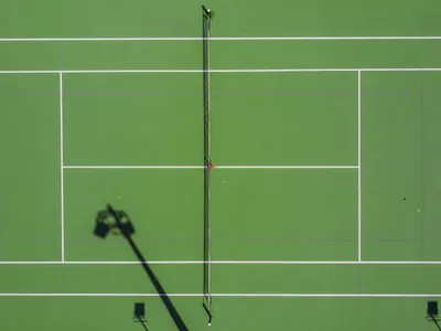 Which line separates the two halves of the tennis court?