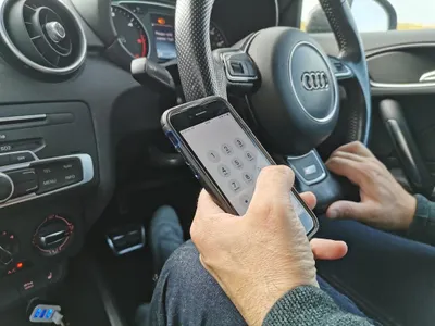 When is it illegal to use a handheld device while driving?