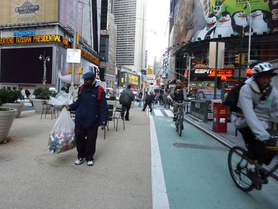 Why is it important to check for cyclists before opening your car door on a street?