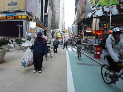 Why is it important to check for cyclists before opening your car door on a street?