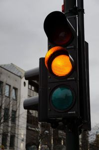 What does a yellow traffic light indicate?