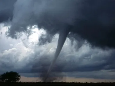 What is the name for a rotating column of air in contact with the ground and extending from a thunderstorm?