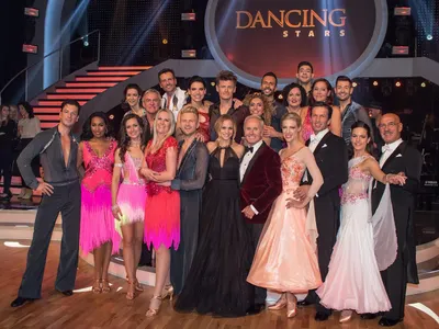 Which show involves celebrities paired with professional dancers in a ballroom competition?