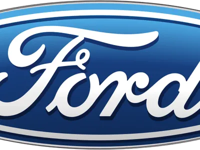 What luxury car brand is known for its 'Screaming Chicken' logo and high-performance Trans Am models?