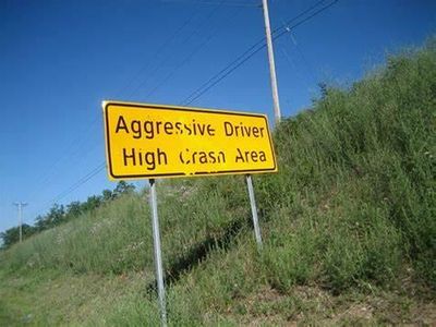 If an aggressive driver is trying to start a fight, you should...