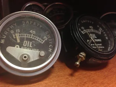 Which of the following is the correct way to check the oil level of a car?