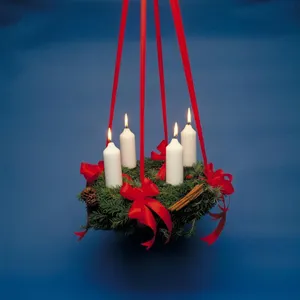 Traditionally, an Advent Wreath in Denmark is made out of fine spruce twigs and cuttings. It is also often decorated with red berries and spruce cones. What is then added for decoration?