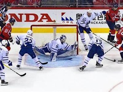 Which sports game is played on ice with a puck?