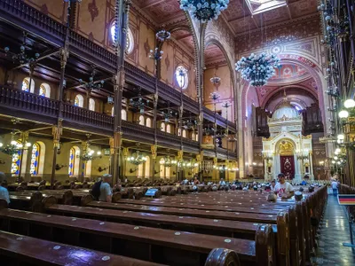Who leads the prayers and services in a synagogue?