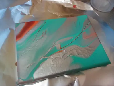Silver paint pour w/ little red and orange. turqouise. I MADE THIS