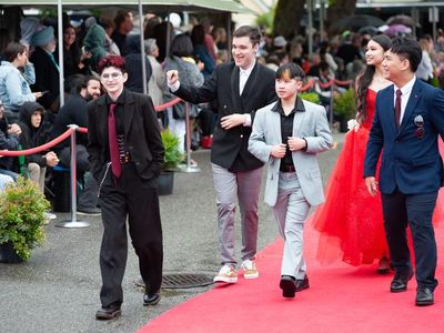 A photo of me with my friends at one of our grad events :) I'm the shorty in the middle