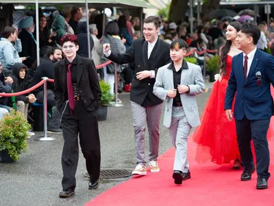 A photo of me with my friends at one of our grad events :) I'm the shorty in the middle