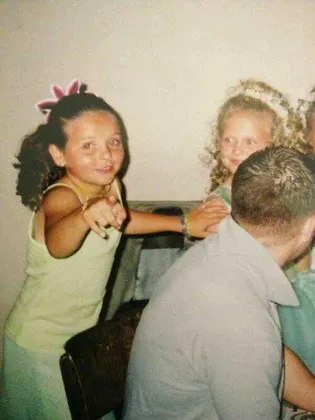 The girl pointing at the camera. :)