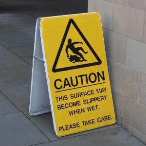 Which surface is known for being slippery in wet conditions?