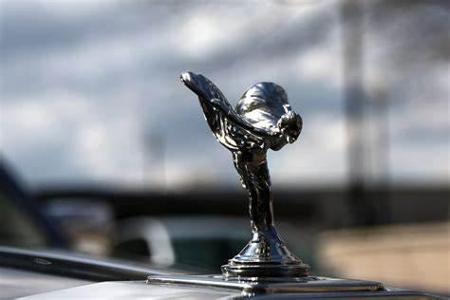 Which luxury car brand is associated with its famous 'Spirit of Ecstasy' hood ornament?