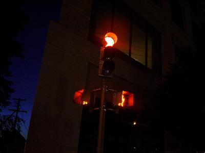 What does a flashing red traffic signal mean?