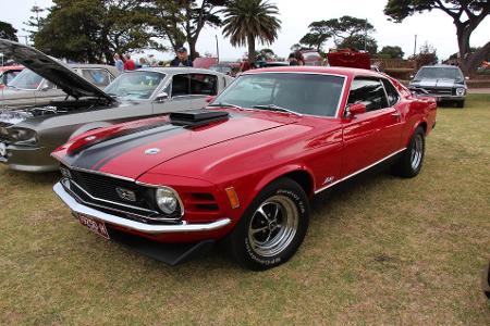 Which muscle car featured the iconic 'Shaker' hood scoop?