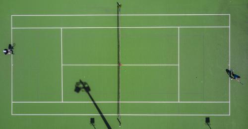 Which line separates the two halves of the tennis court?