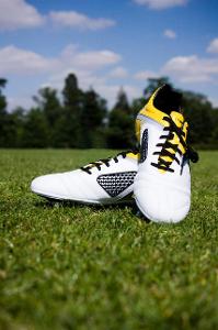 What type of shoes are generally used for playing football?