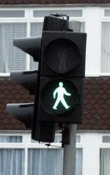 You want to cross the road and ahead of you is a road crossing (Pelican crossing). As you reach it the lights show the green man flashing. Can you..