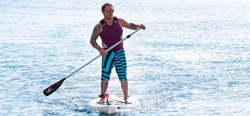 Which activity involves using a paddleboard and a paddle to navigate waterways?