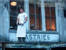 What is the name of the song that peeta remebers Katniss singing on the first day of school