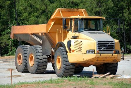 Which type of truck is designed to carry heavy loads and is commonly used in construction sites?