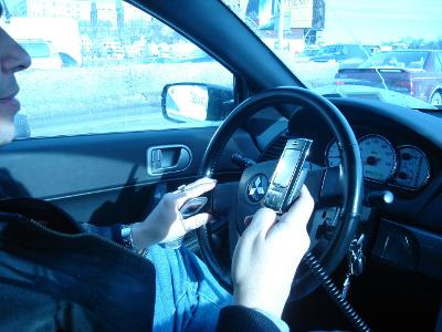 When is it acceptable to use a mobile phone while driving?