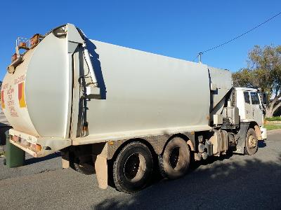 What type of truck is used for picking up and transporting waste materials?