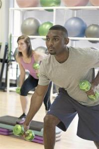 Aerobic exercise can help with weight management by:
