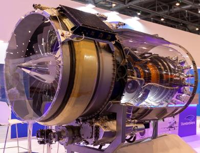 How does a turbojet engine produce forward thrust?
