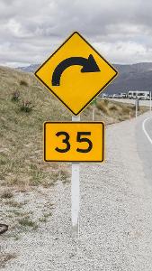 What is the advisable speed when entering a curve or bend?
