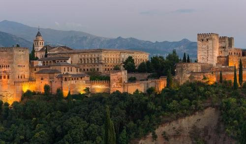 Which city is home to the magnificent Alhambra palace?