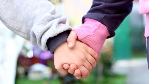 As a punishment for fighting at school, two kids could either be suspended or hold hands for an hour.