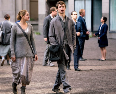 What was the name of the boy who is Tris' neighbor when she is still in abnegation?