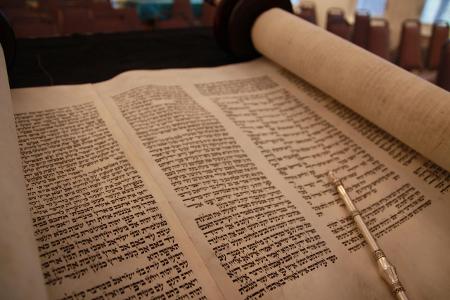 Which sacred text contains the Jewish oral law and rabbinic interpretations?