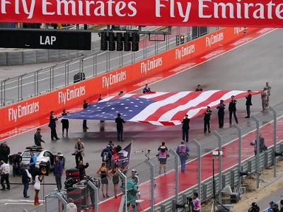 Which driver celebrated his F1 win by climbing the fence at the Circuit of the Americas?