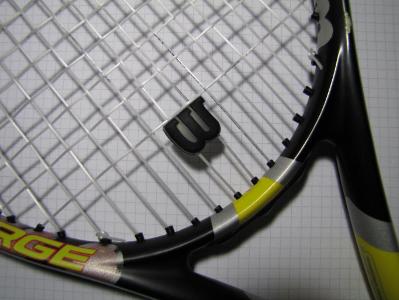 What is the purpose of a racket dampener in tennis?