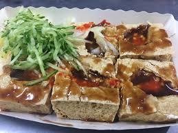 "Stinky tofu is a Taiwanese form of fermented tofu that has a strong odor. It is usually sold at night markets or roadside stands as a snack, or in lunch bars as a side dish, rather than in restaurants." Wikipedia.  Stinky tofu?